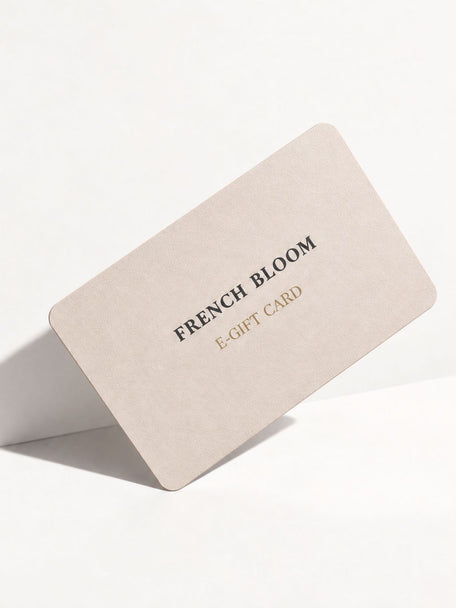 A minimalist beige e-gift card with rounded corners, featuring the text 'FRENCH BLOOM' in black and 'E-GIFT CARD' in gold, displayed on a clean white background.