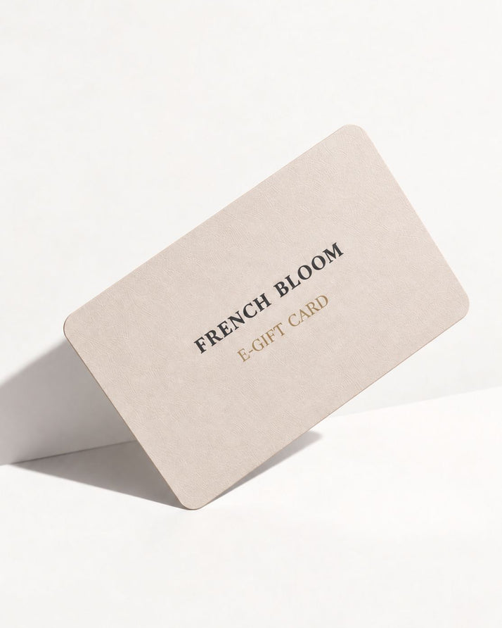 A minimalist beige e-gift card with rounded corners, featuring the text 'FRENCH BLOOM' in black and 'E-GIFT CARD' in gold, displayed on a clean white background.