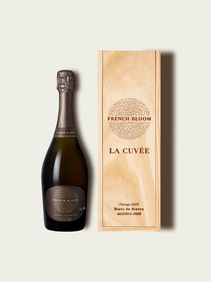 Bottle of French Bloom sparkling wine  and wooden box on a white background