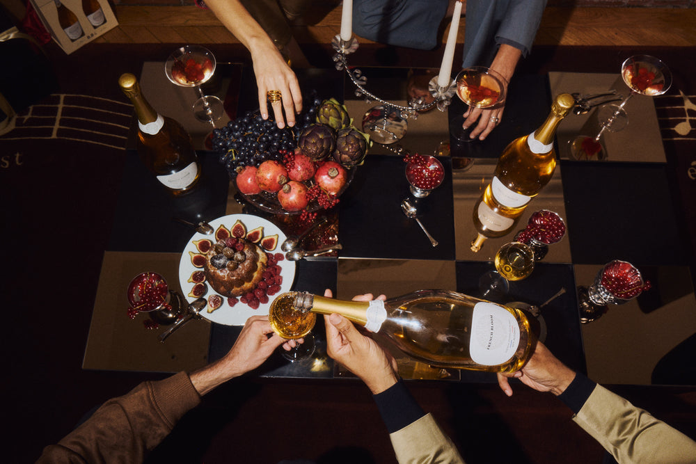 French Bloom poured into flutes around a dinner table, seen from above