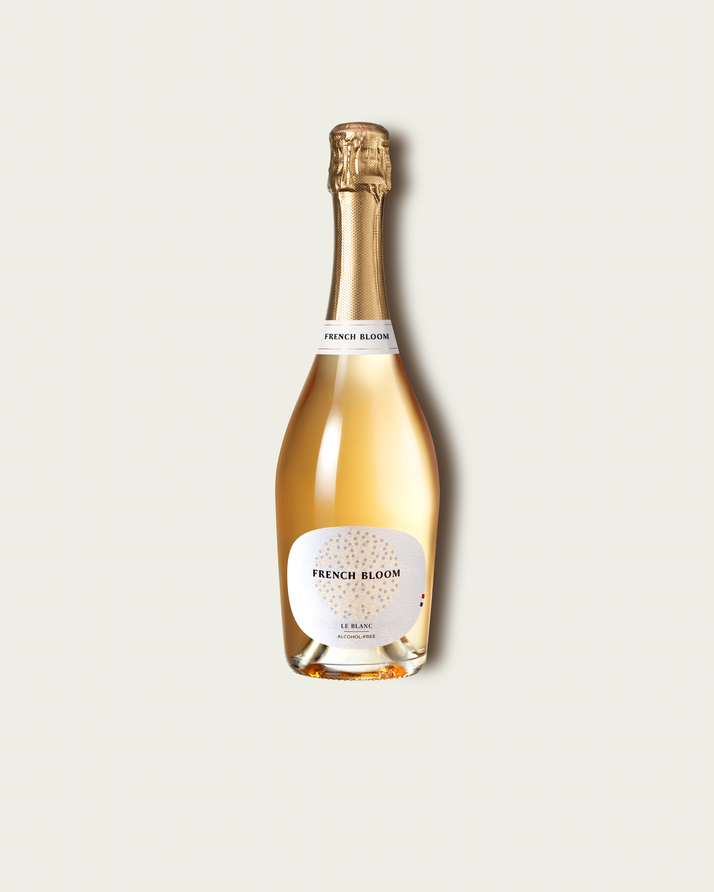 French Bloom Le Blanc 0.0% alcohol bottle on a minimalist off-white background.