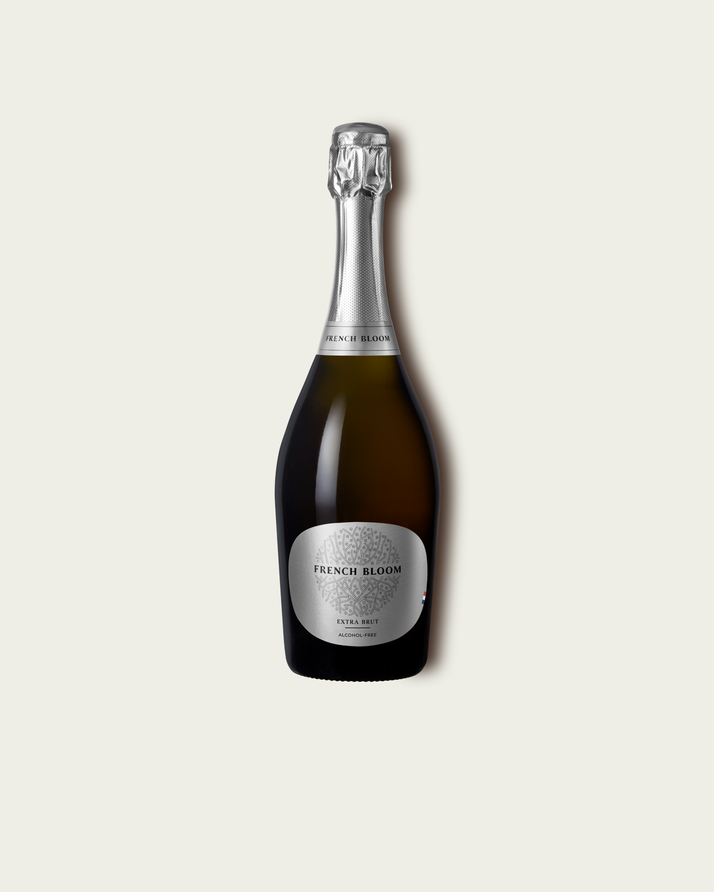 French Bloom L’Extra Brut 0.0% alcohol bottle on a minimalist off-white background.