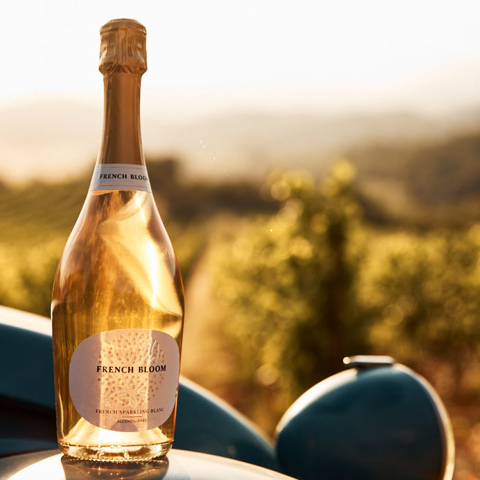a bottle of French Bloom rosé on the hood of a car 