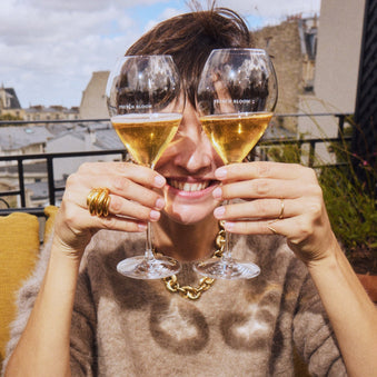 a girl with wine glasses over her eyes 