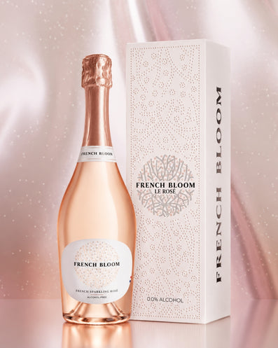 French Bloom “Le Rosé” and its gift set set against a backdrop of pink glitter