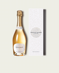 A bottle of French Bloom Blanc non-alcoholic sparkling wine with gold foil and a white label, shown next to its tall white patterned box on a light beige background.