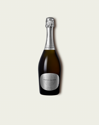French Bloom L’Extra Brut 0.0% alcohol bottle on a minimalist off-white background.