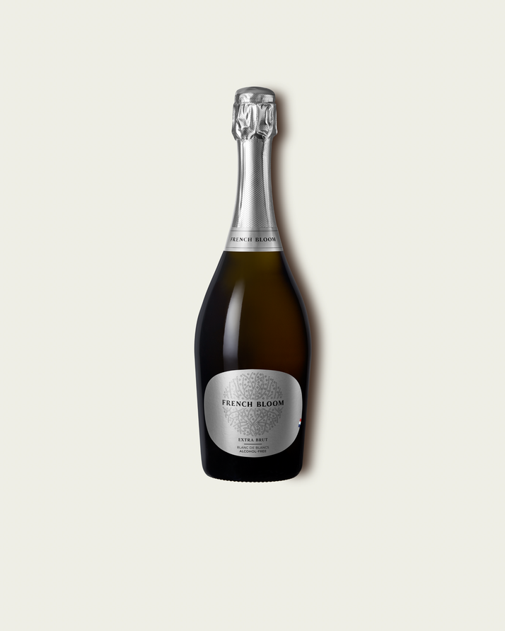 French Bloom L’Extra Brut 0.0% alcohol bottle on a minimalist off-white background.
