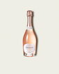 A bottle of French Bloom Le Rosé with pale pink liquid, a white label, and a metallic rose gold foil top, centered on a light beige background.
