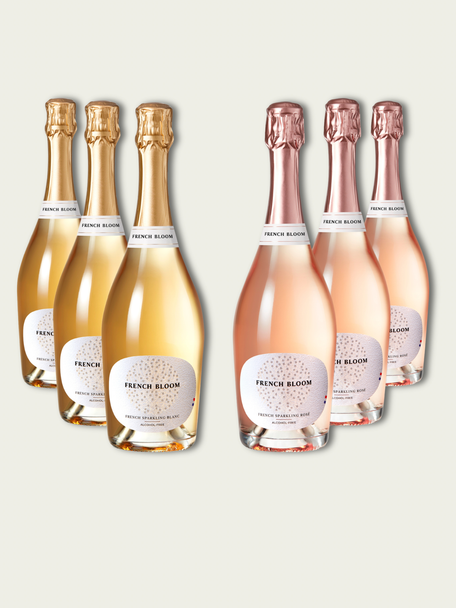 Six bottles of French Bloom sparkling wine, featuring three Le Blanc with pale golden liquid and gold foil tops and three Le Rosé with pale pink liquid and rose-gold foil tops, set against a light warm-gray background.