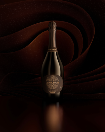 French Bloom La Cuvée Vintage 2023 bottle set against a deep brown sculptural background.