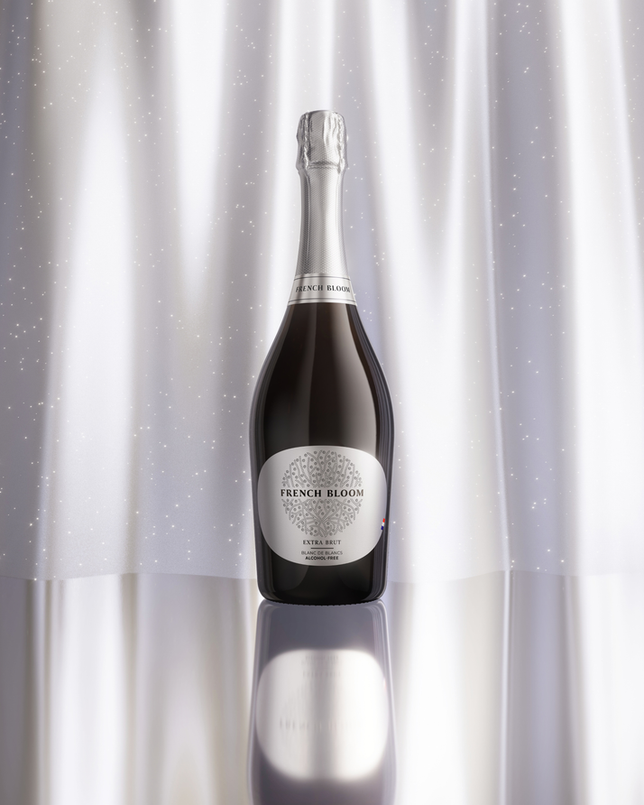 French Bloom Extra Brut bottle against an elegant silver luminous background.