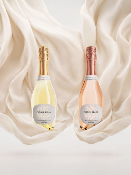 French Bloom Le Blanc and Le Rosé half bottles set against flowing ivory fabric.