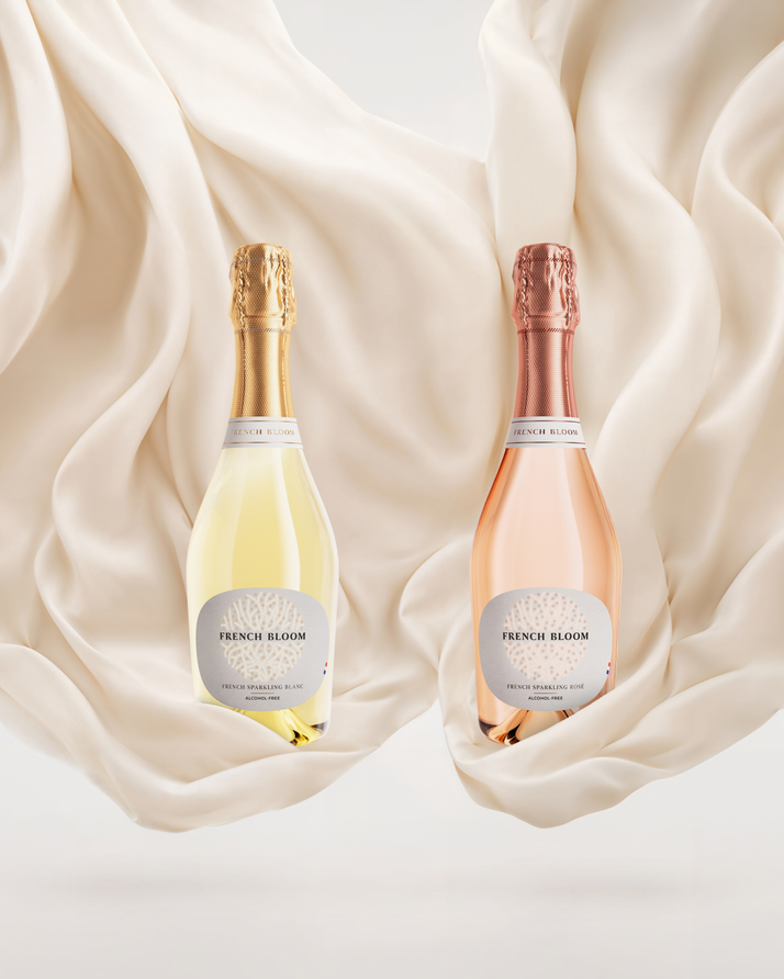 French Bloom Le Blanc and Le Rosé half bottles set against flowing ivory fabric.