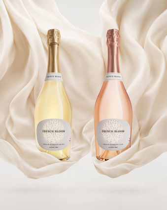 French Bloom Le Blanc and Le Rosé bottles set against flowing ivory fabric.