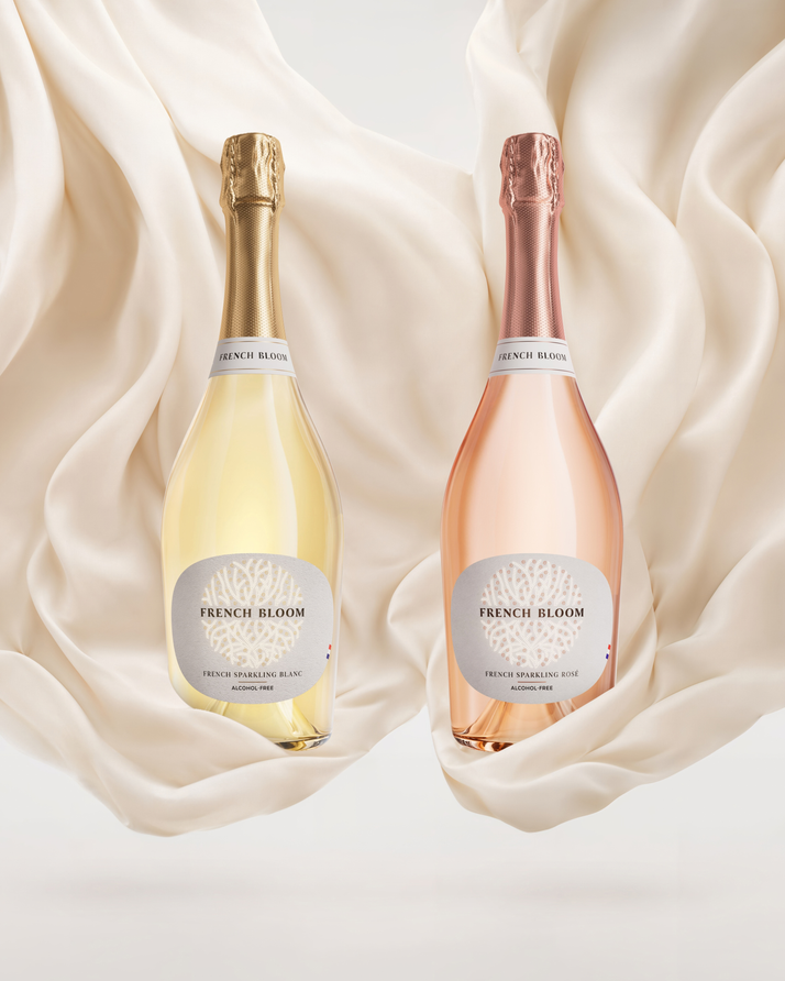 French Bloom Le Blanc and Le Rosé bottles set against flowing ivory fabric.