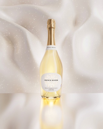 French Bloom Le Blanc bottle against an elegant luminous ivory background.